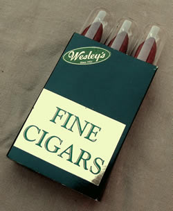 Sleeves of three cigars in glass tubes